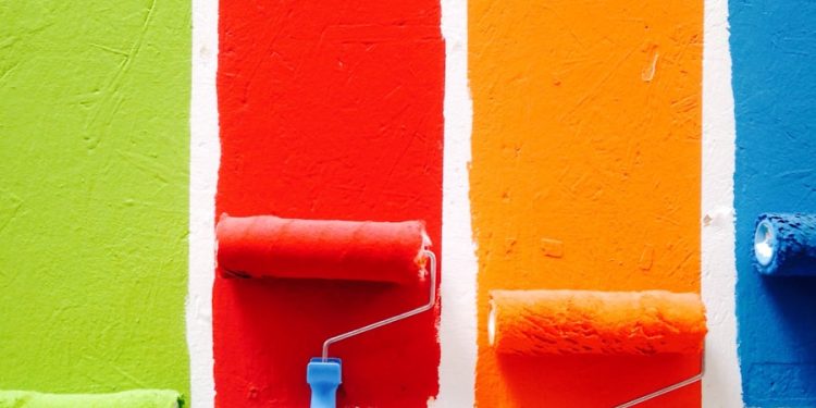 four orange, green, blue, and red paint rollers