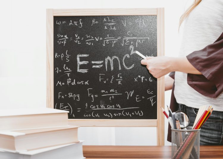 E-mc2 written on chalkboard