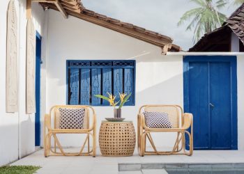 wicker table and two chairs near swimming pool