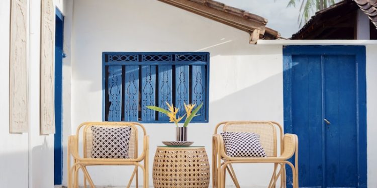 wicker table and two chairs near swimming pool