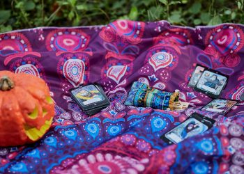 black smartphone on red and white textile