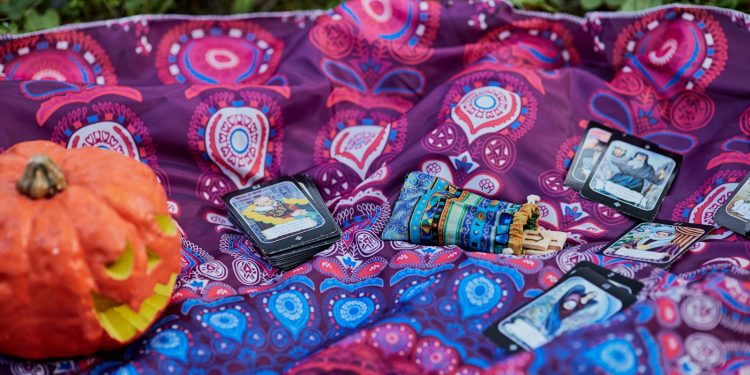 black smartphone on red and white textile