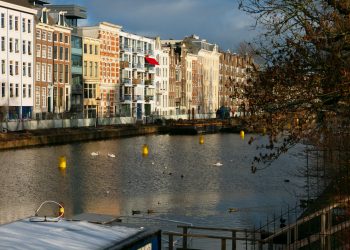 a body of water surrounded by tall buildings