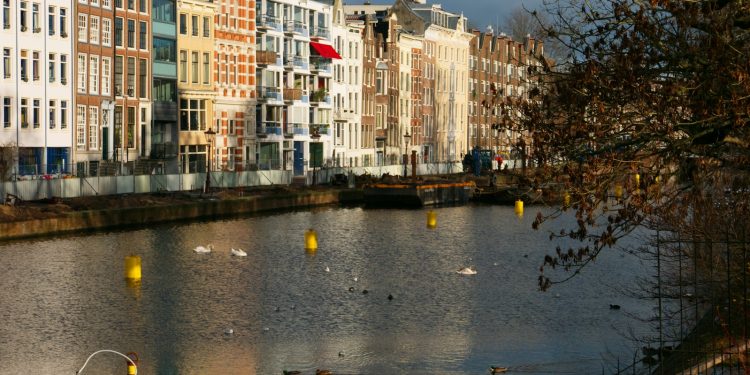 a body of water surrounded by tall buildings
