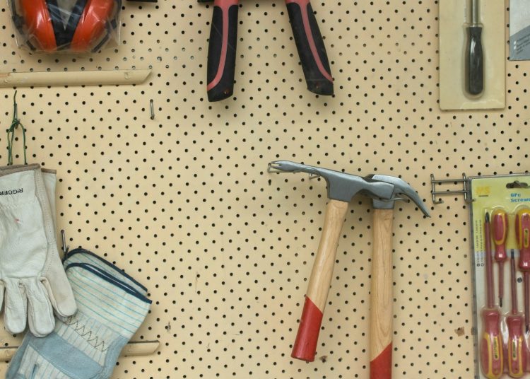 black and silver claw hammer beside red and black hand tool