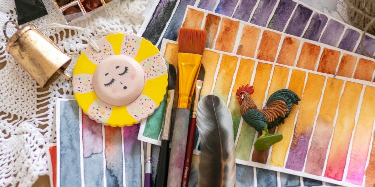 brown wooden handled brush beside white round plastic