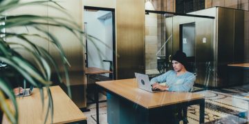 man using a gray laptop computer