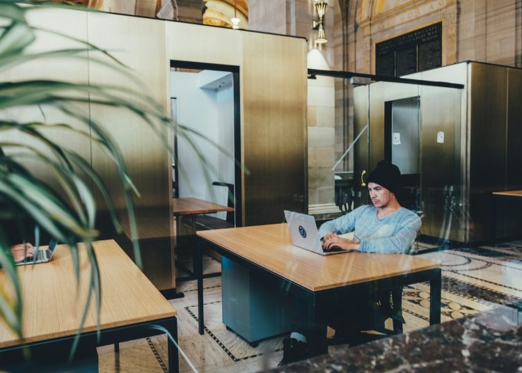 man using a gray laptop computer