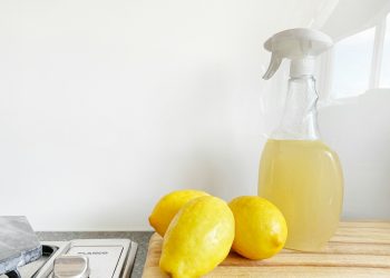yellow lemon fruit beside clear glass bottle