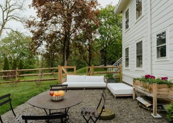 a patio with a table and chairs and a couch