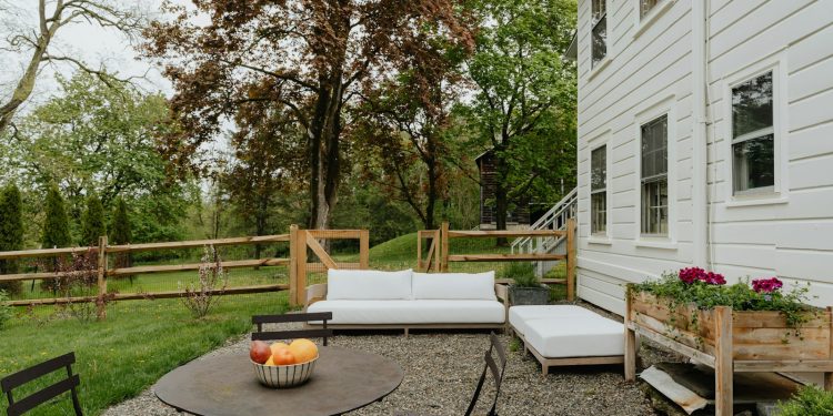 a patio with a table and chairs and a couch