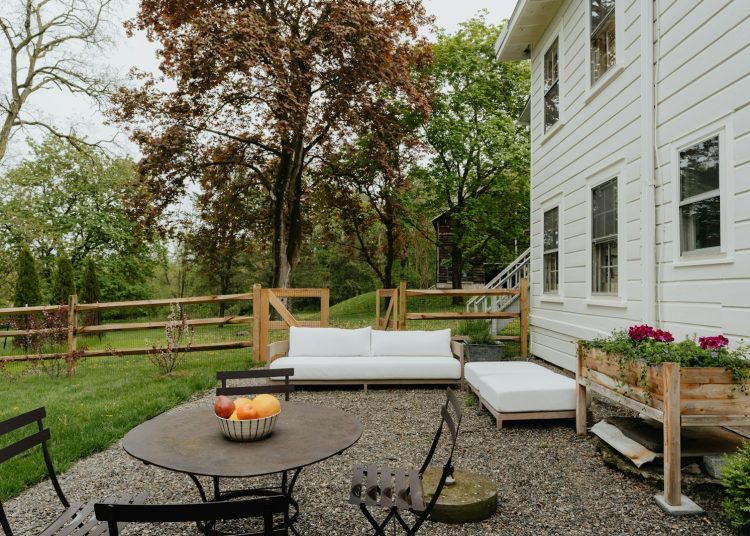 a patio with a table and chairs and a couch