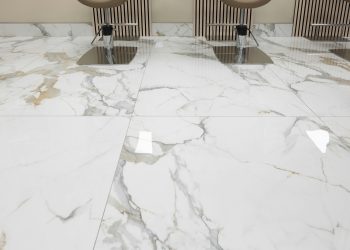 three chairs sitting on a marble floor in a room
