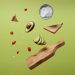 sliced avocado, tomatoes, and bread on a green surface